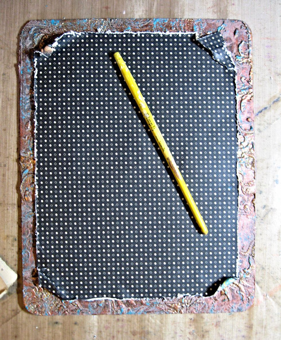 Use a paintbrush handle to roll and further distress corners.