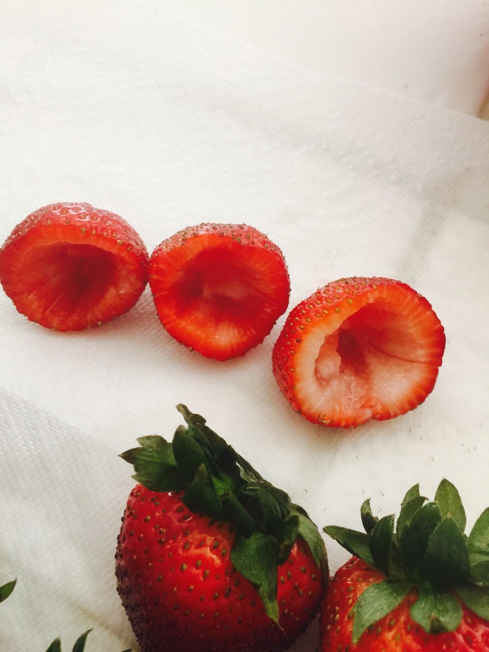 Use a pairing knife to get the middle out of the strawberries