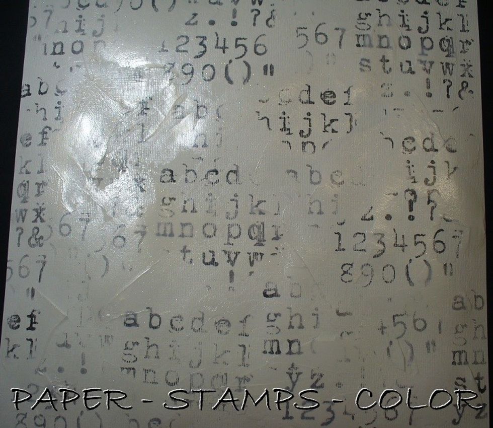 Use a palet knife to scrape Frost Sorbet Clear Coat randomly to tone down the stamping, and add shimmer to the page. Add texture to the page with stencils and texture paste. Leave to dry.