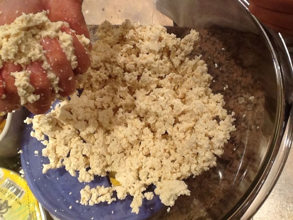 Use a paper towel to gentle press and squeeze the water out of the tofu. It takes awhile so be patient- you don't want your filling watery. When finished, mash it up with your hand.
