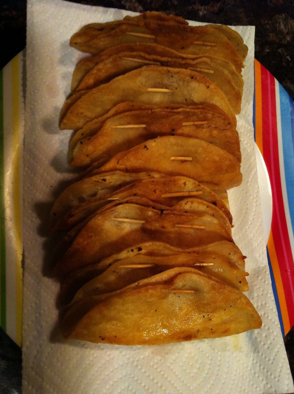 Use a paper towel to lay your tacos on so the oil stays there when draining, but right before serving REMOVE toothpicks.