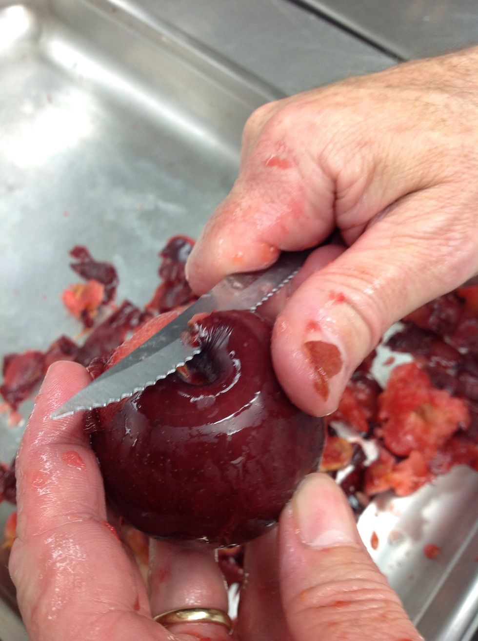 Use a paring knife to peel the skin from the plums and remove pit.