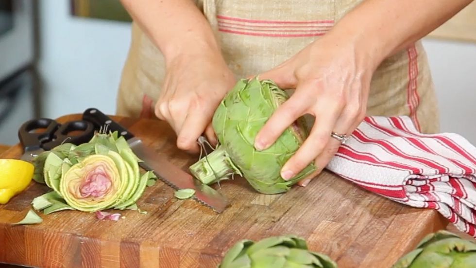 Use a paring knife to trim the root end, or stem, of the artichoke.