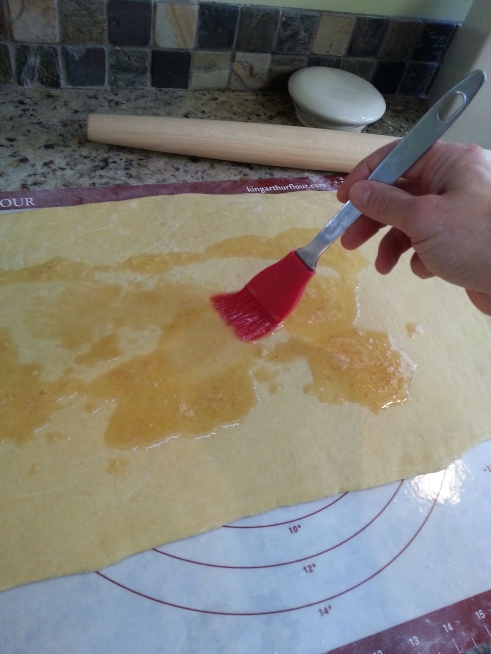 Use a pastry brush to spread melted butter across all of the dough.
