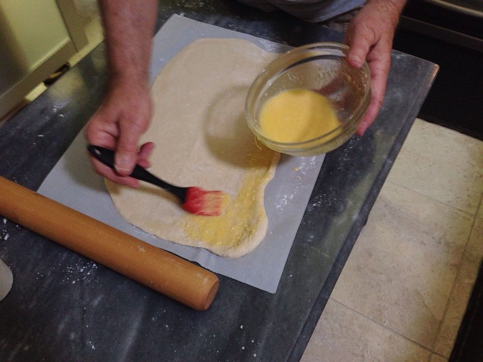 Use a pastry brush to spread the mixture over the dough.