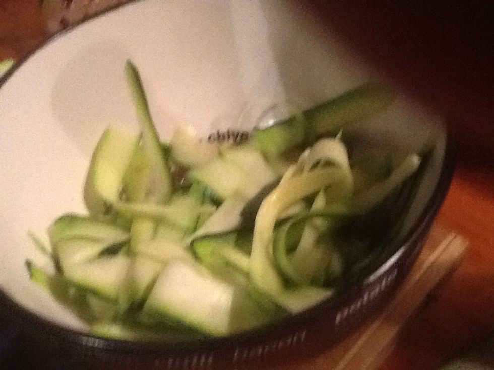 Use a peeler to, well, peel two zucchini into the bowl. The salad is ready but don't toss it until about to be served.
