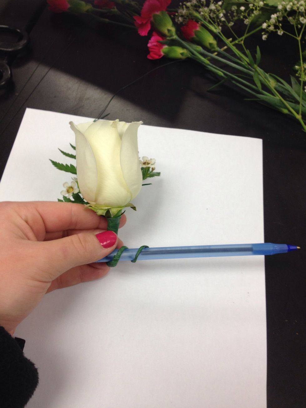 Use a pen, pencil, or leftover stem to wrap wire outward and around to create a "pigtail".