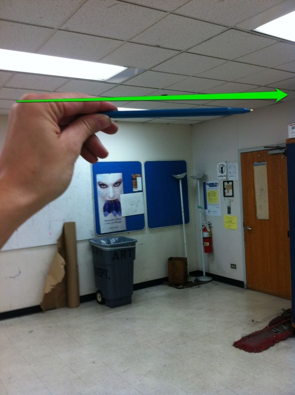 Use a pencil. Hold it completely horizontal and parallel to your body. Close one eye and compare this horizontal line with the ceiling.