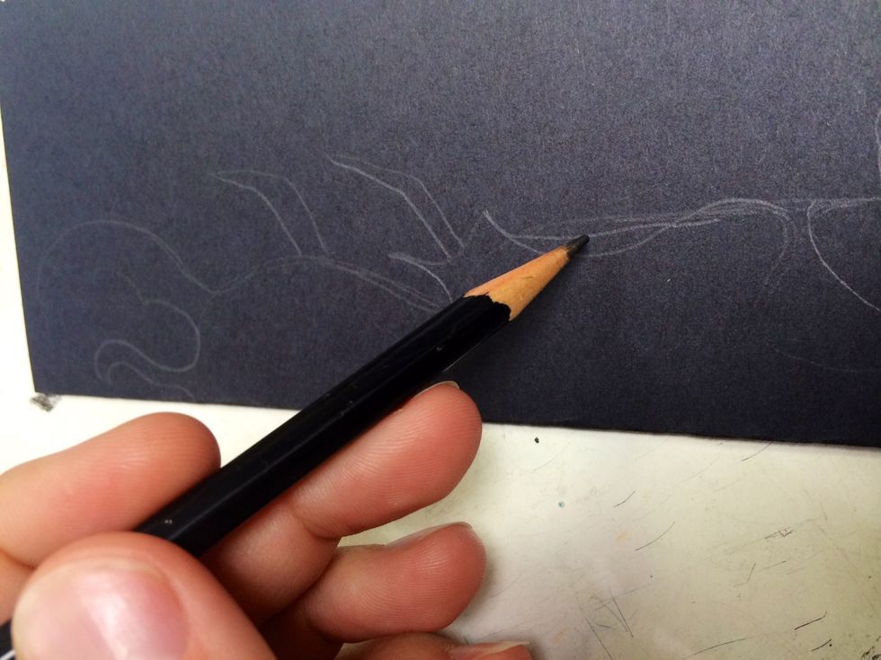 Use a pencils to draw a continuous organic line along the fold of the black paper.