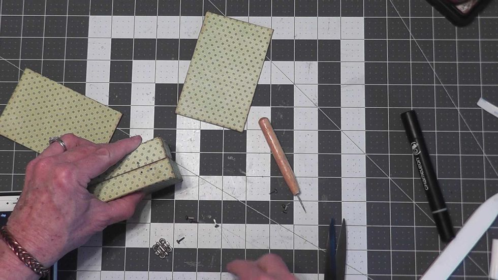 Use a piercing tool to make the holes for the hinges as marked on your box.