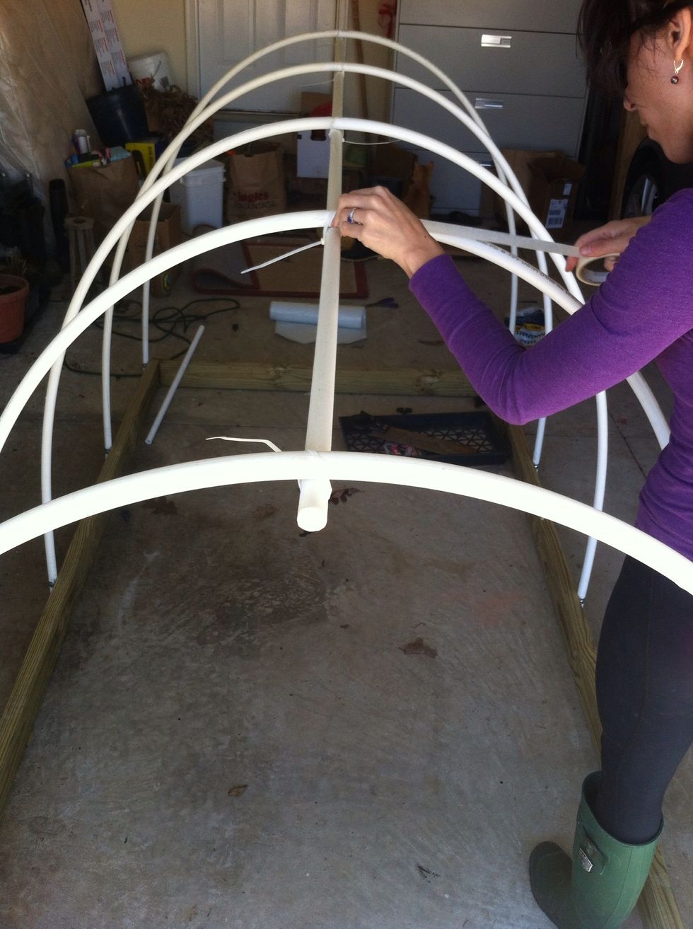 Use a plastic cutter or saw to cut top-mounted PVC to proper length (8 ft). Then attach top-mounted PVC piece to center of hoops using plastic cable ties (add duct tape if desired; we just used ties).