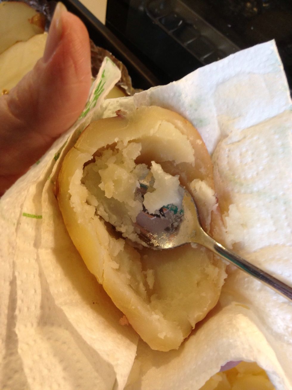 Use a potholder or layered paper towel to hold the potatoes, they are hot! Carefully scoop out the inside of the potato. Leave a thin layer of potato next to potato skin.