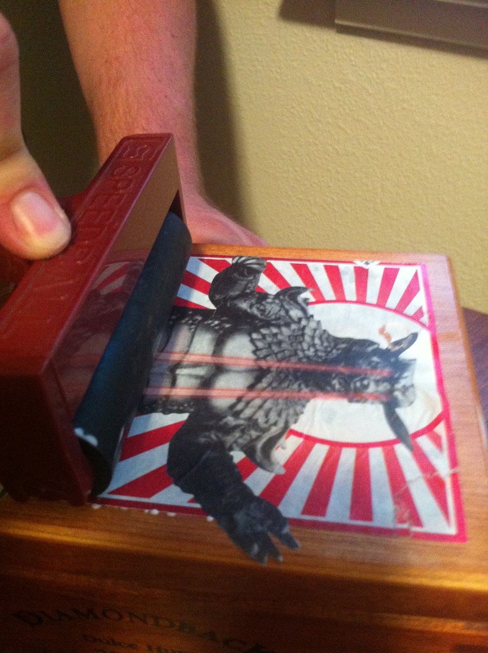 Use a roller if you have one. Be aware of excess glue the roller picks up, as it can pull or tear images. One quick roll should suffice.