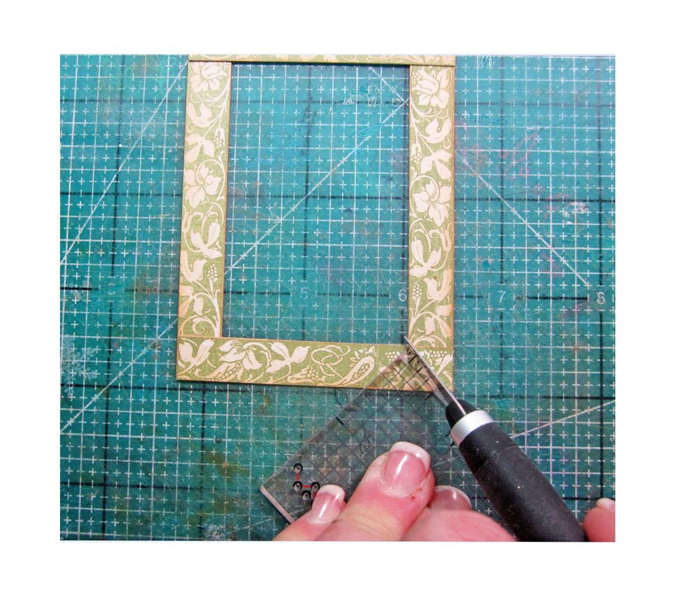 Use a ruler line up in the corners from inner corner to outer corner and the cut with X-acto tool on the top layer only to mitered the edges.