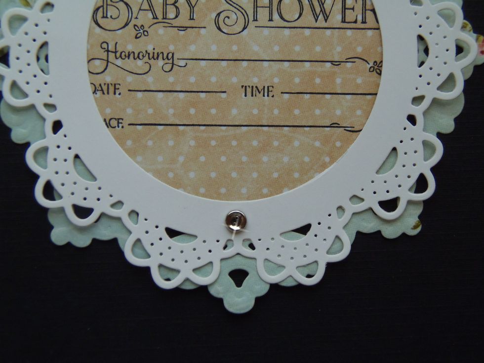 Use a small brad to hold both doilies together.