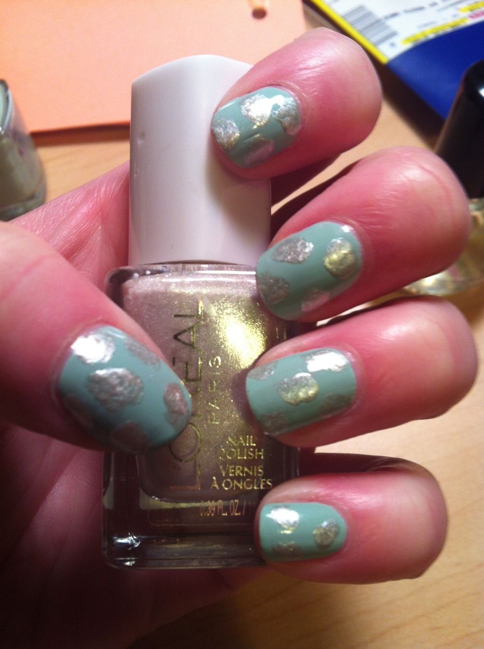 Use a small pain brush to smudge irregular spots with your accent color. Space them as you like! These don't have to be perfect at all, the edges will be mostly covered by black in the next step.