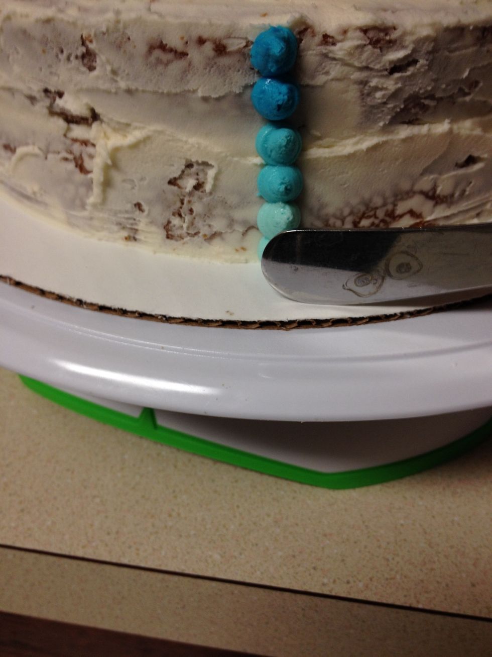 Use a small un-serrated knife to pull the dots across the cake a bit (make sure to wipe off the knife after each pass)