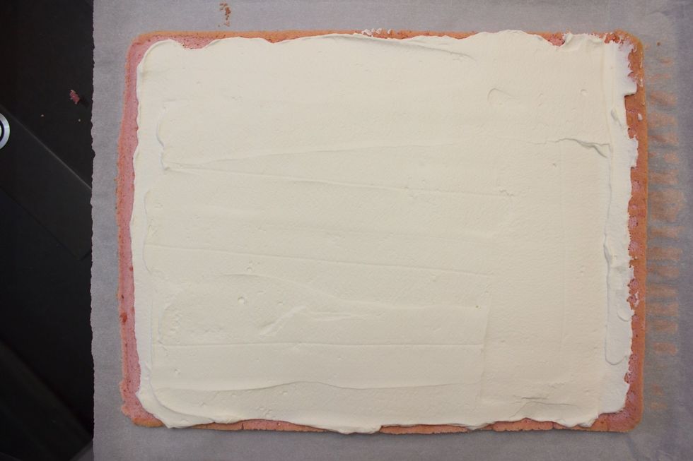 Use a spatula to even out the filling while leaving 1-2 cm un-frosted around the perimeter so the filling doesn't squeeze out during the rolling process.