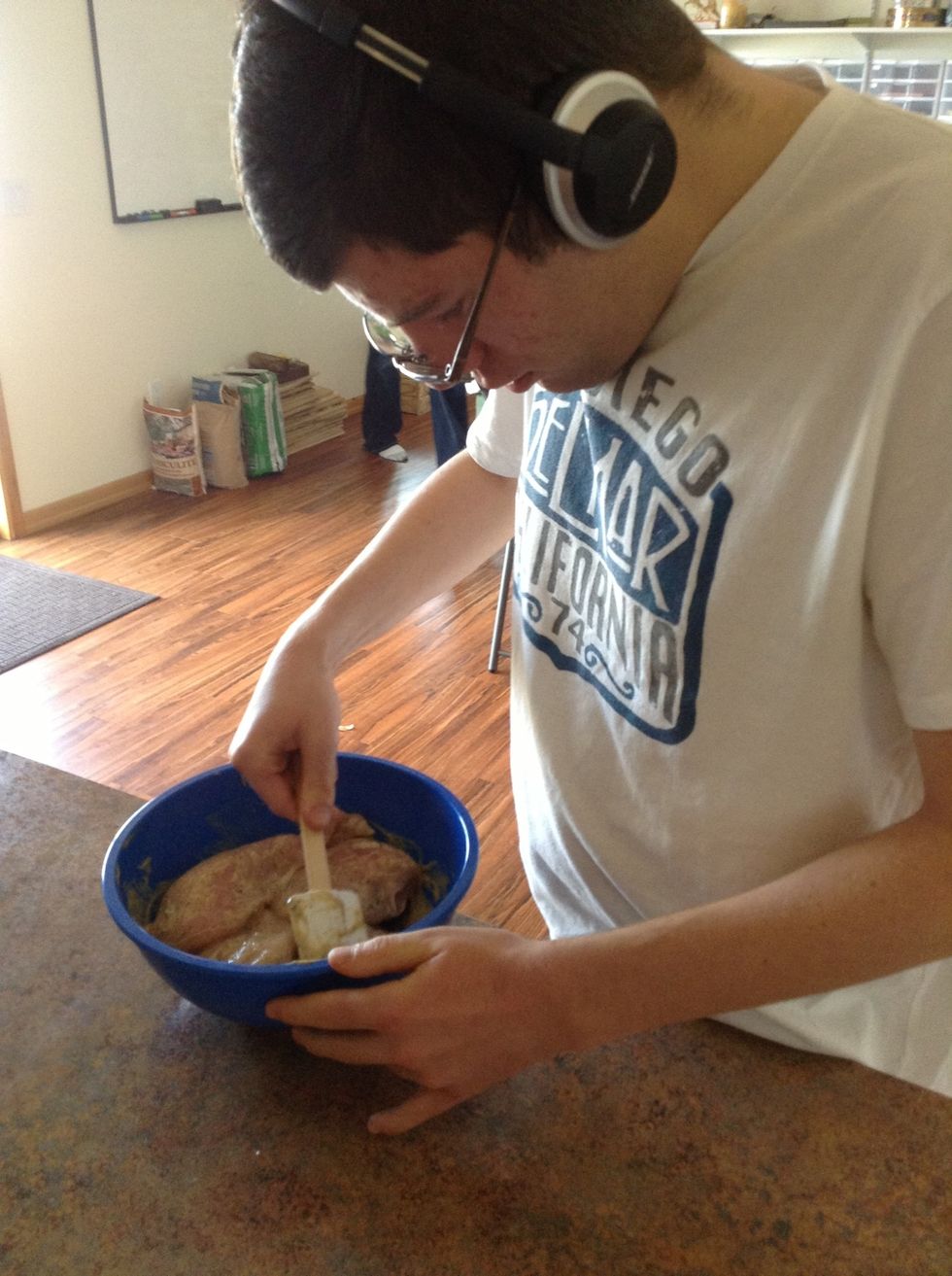 Use a spatula to mix the chicken and the mustard together so that the chicken is completely coated