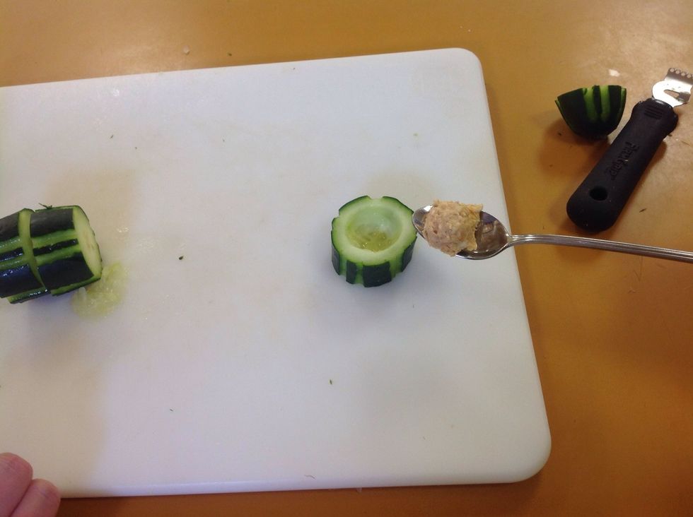 Use a spoon and fill the center of the cucumber with the feta filling. Wipe off the sides of the cucumber to have a nice clean great looking appetizer.