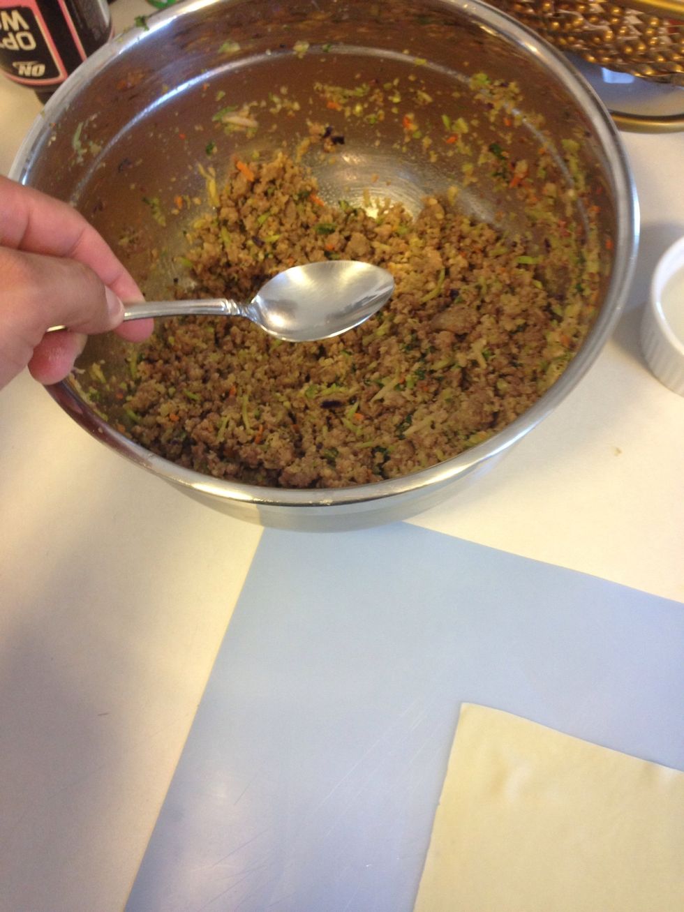 Use a spoon and spoon about 1-1 1/2 tablespoons of the mix onto wrapper, don't overfill and tear wrappers... I saved 1/4 of this mix for the pancit as well