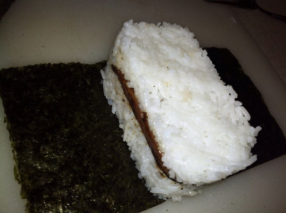 Use a spoon (or your musubi handle), press down on the rice and use your other hand to pull the mold up and release the musubi.