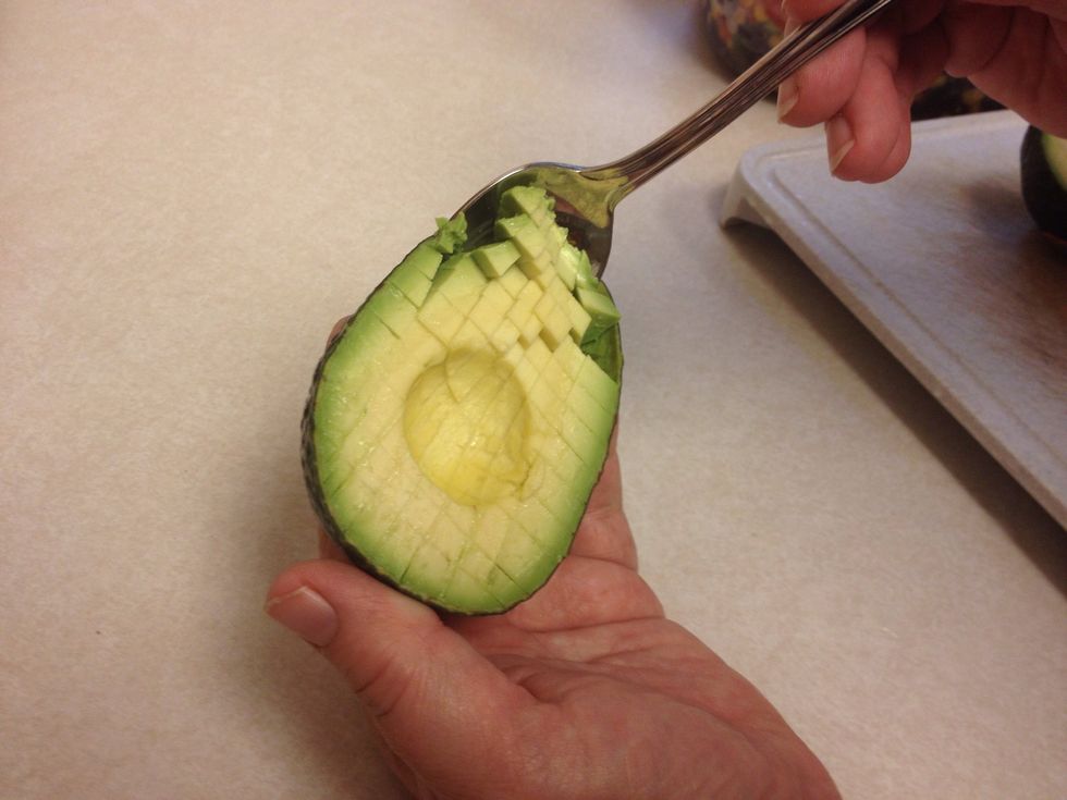 Use a spoon to scoop out the avocado.