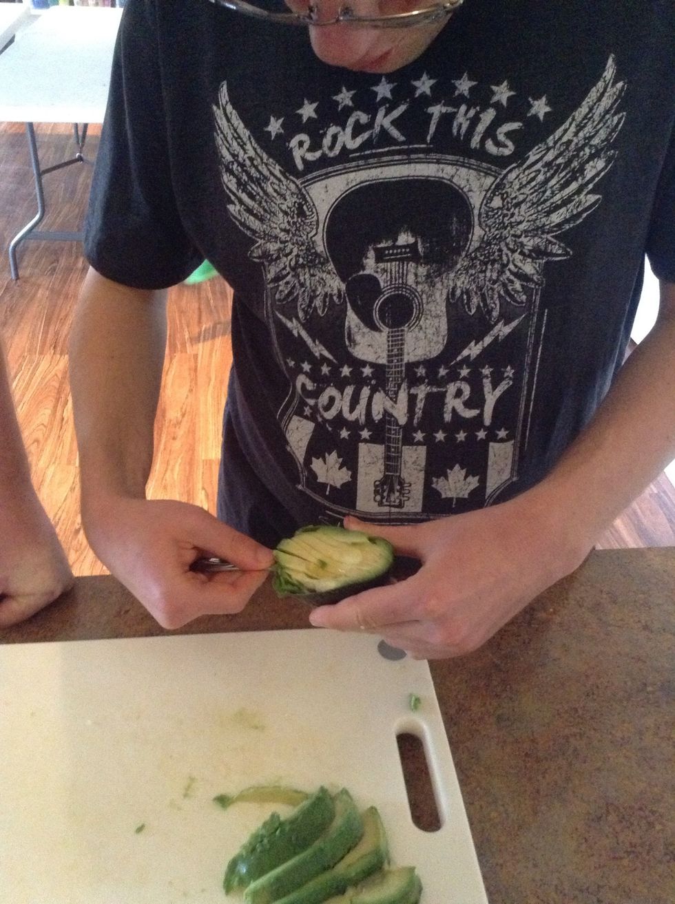 Use a spoon to separate the avocado skin from the flesh