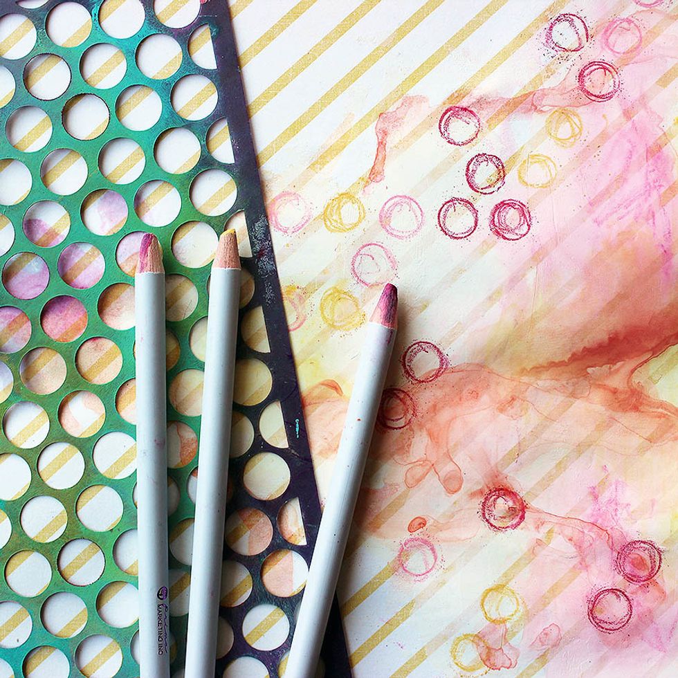 Use a stencil as a guide to add little circles. Go over the shapes with a waterbrush to soften the look. Dry.