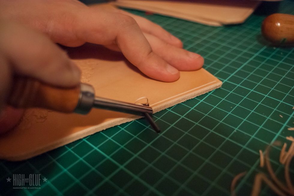 Use a stitching groover to create the sewing groove. Just slide it along the edge. You won't have to groove the side where the spine will be attached. We'll put some leather on top of that, later.