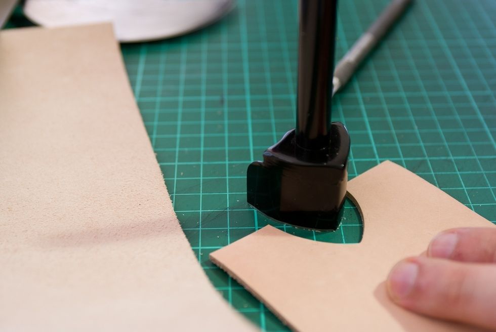 Use a strap end punch to punch a hole into the thick inside piece. This makes it easer to take out the phone