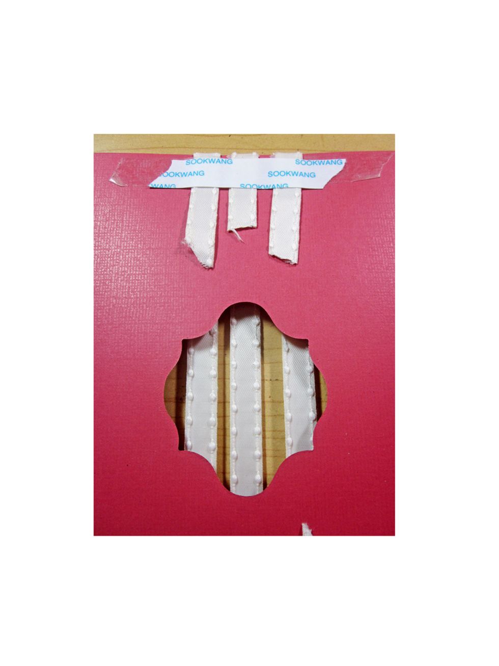 Use a strong glue and wrap the ribbon to the back and glue down. Do the same on the bottom portion too!