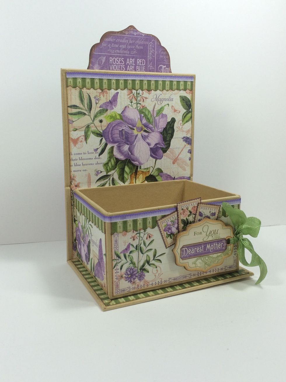 Use a strong glue to adhere the large chipboard piece to the back of the wall as shown. Add the chipboard tag and three postage stamp cut-aparts to the box's front.