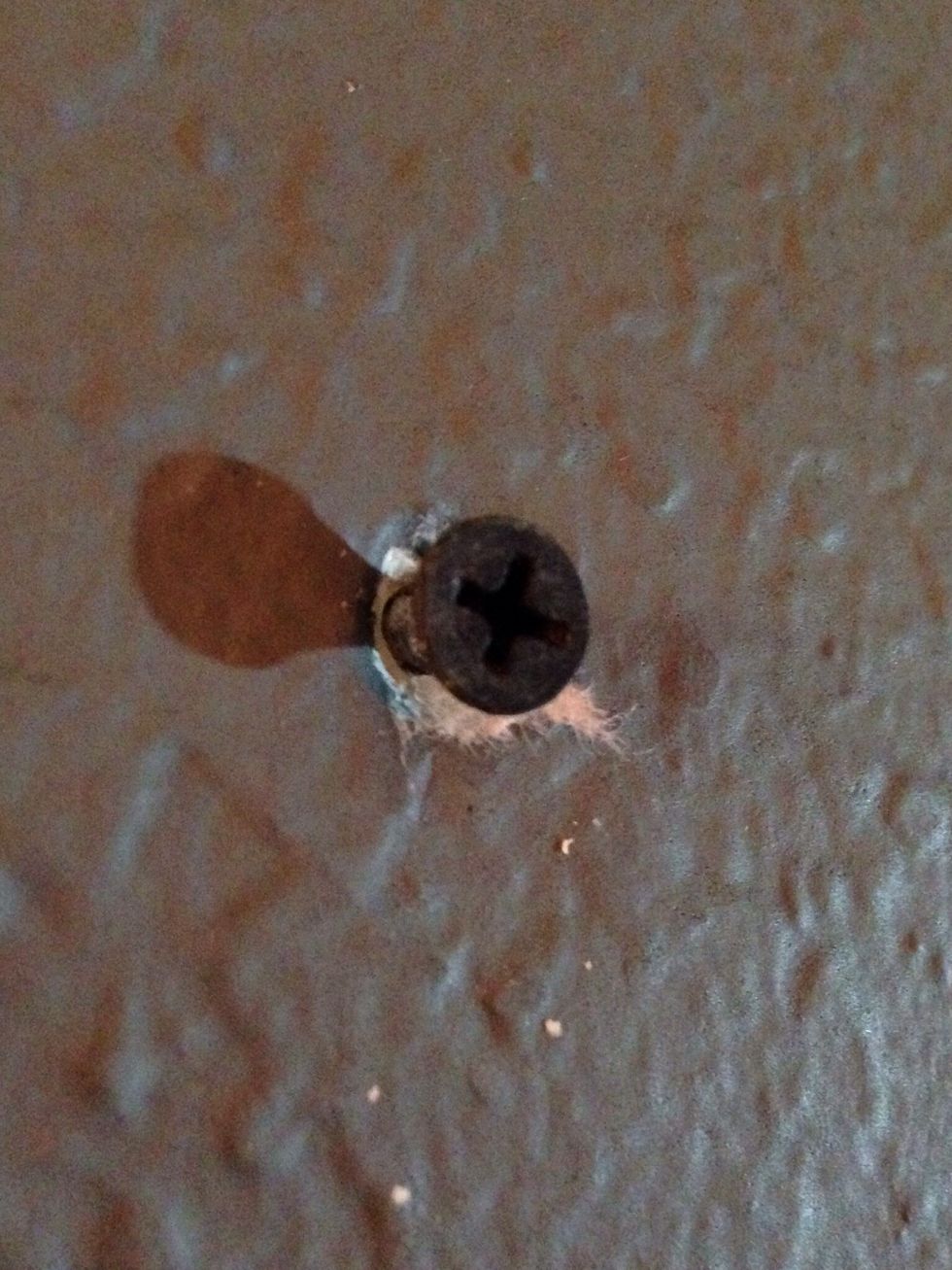 Use a stud finder to find your drilling locations. Once discovered use whatever screws you have around the house and drill it to the amount you see in the picture.