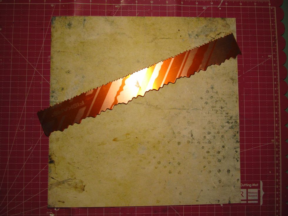 Use a tearing ruler with an uneven distressed edge (or just rip it free handed) on an angle and tear your paper.