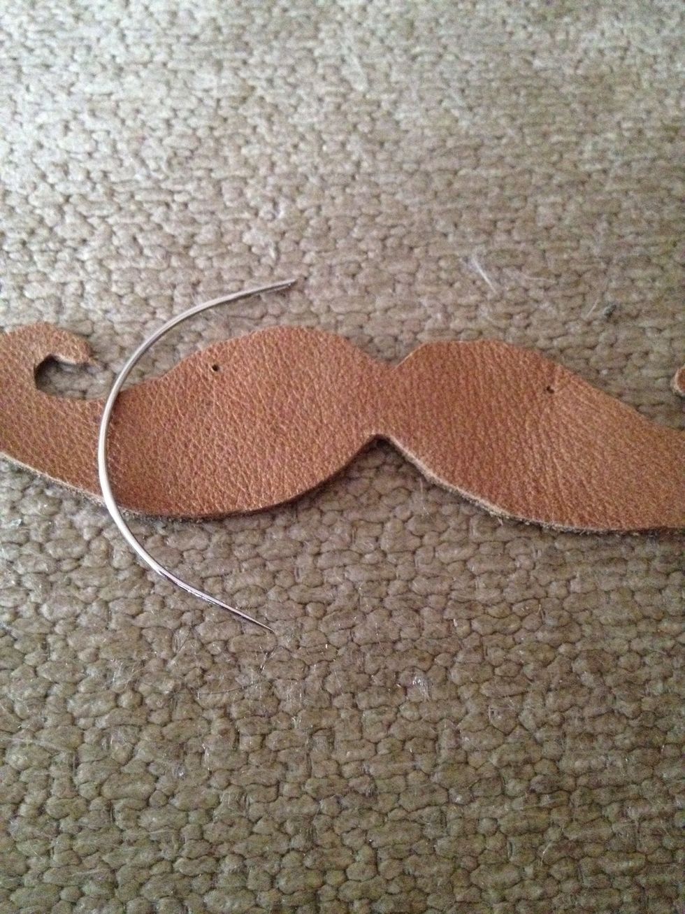 Use a thick needle or another sharp object to puncture two holes on both sides of the mustache. I used an upholstery needle cuz it was thicker.