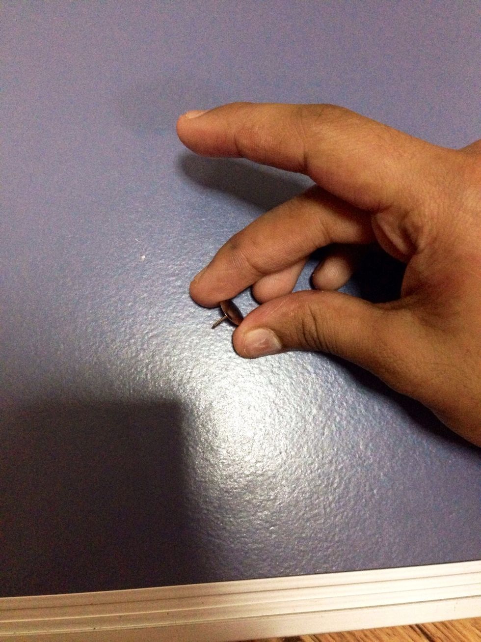 Use a thumb pin to see if it will go inside the back of the whiteboard.