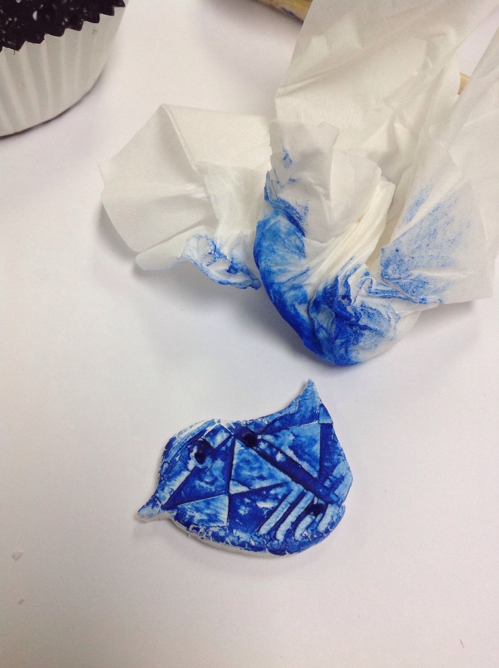 Use a tissue or rag to wipe off excess paint.