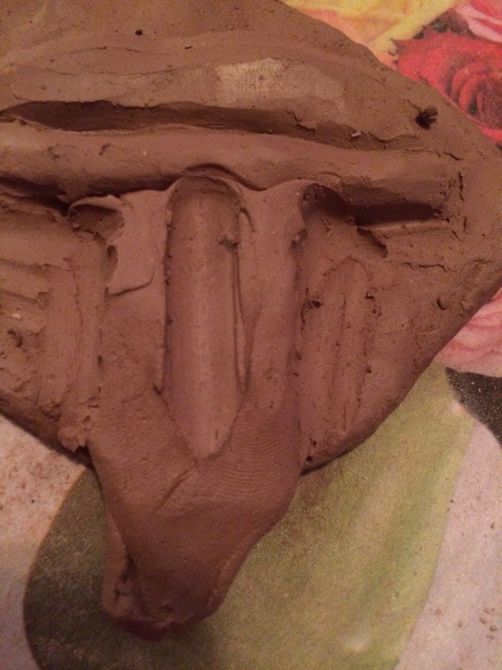 Use a tool to start sculpting the ridges in the philtrum. The top of the ridges connect to the high points on your top lip.