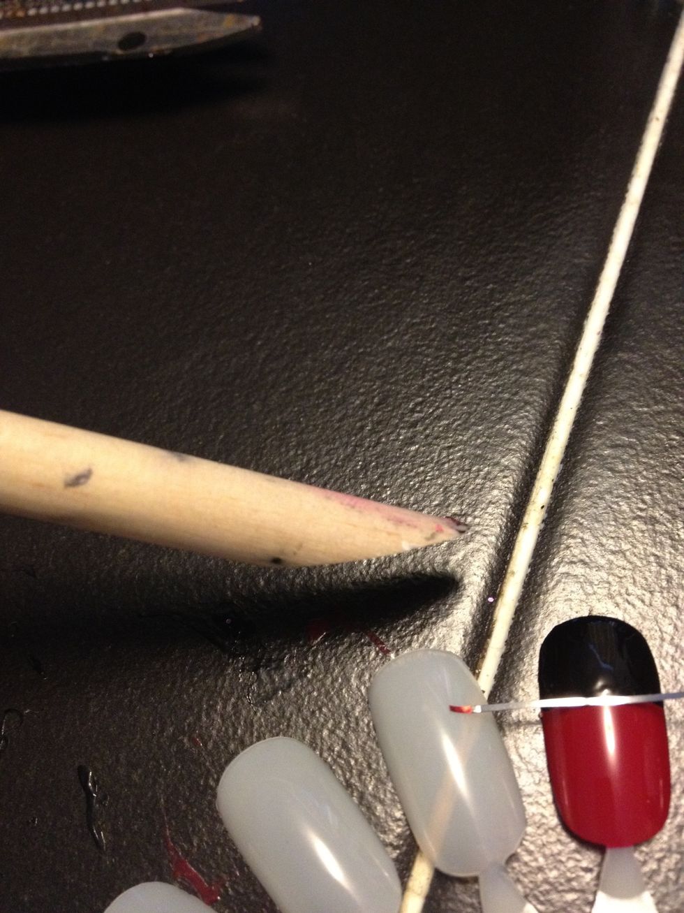 Use a toothpick, or cuticle pusher :)