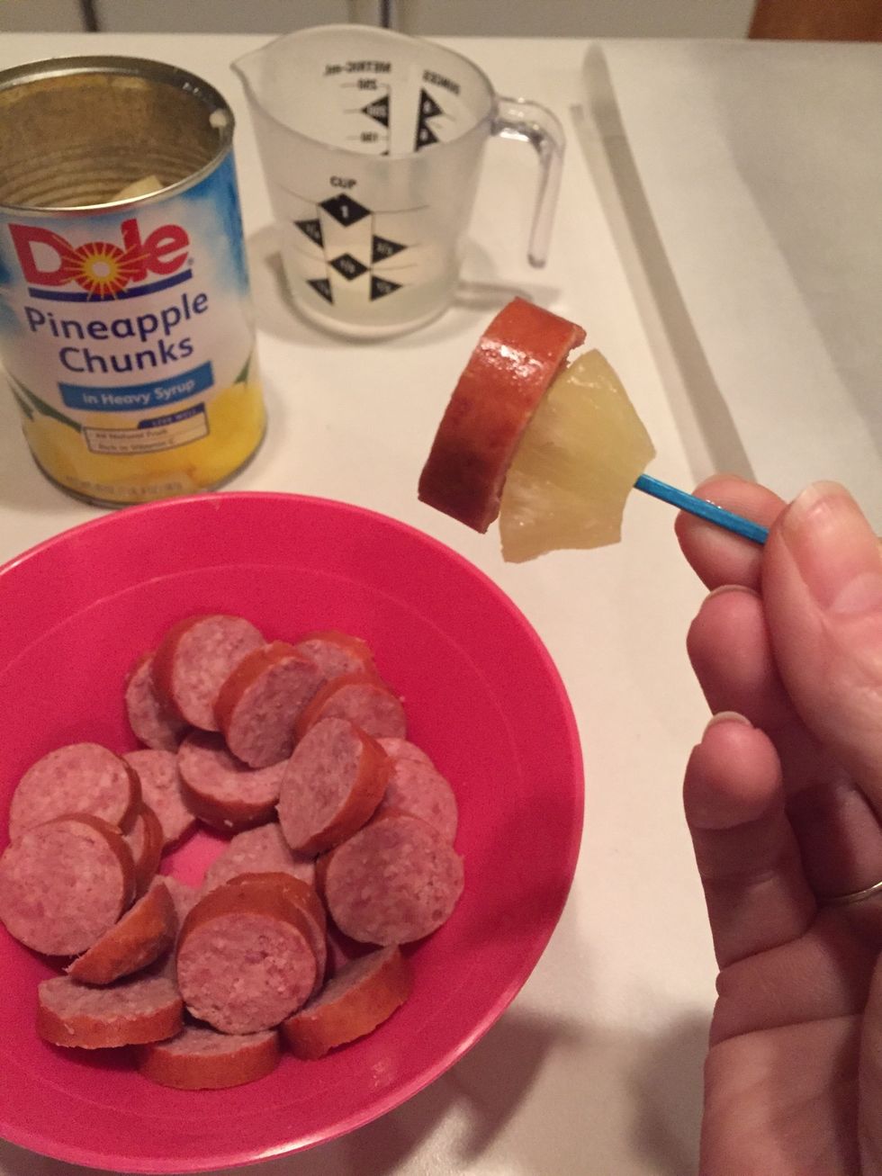Use a toothpick to spear one piece of pineapple and one slice of kielbasa.