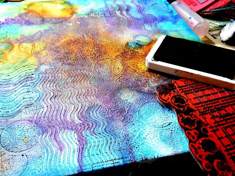 Use a Tsukineko Memento luxe ink pad in "tuxedo black" to stamp random images onto the background. I used a stamp from Indigoblu called "Ledger background".