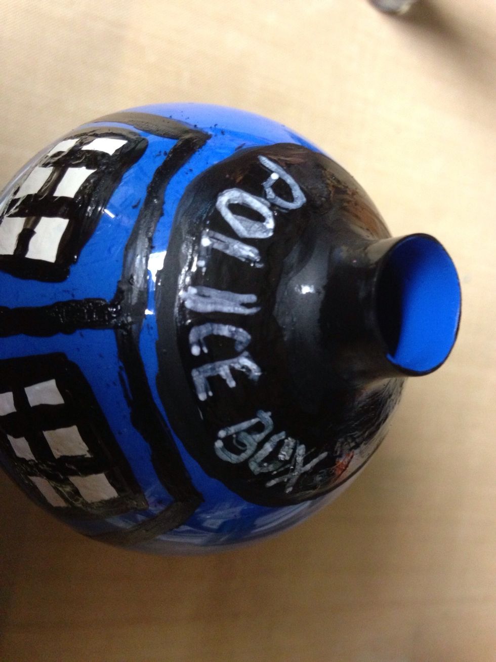 Use a white marker and print Police Box on top of ornament.