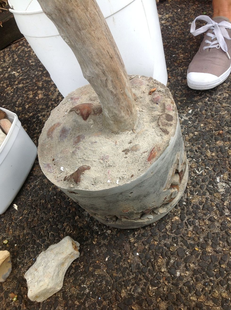 Use a wire brush to roughen or remove any unwanted concrete dags and to expose rocks as a feature