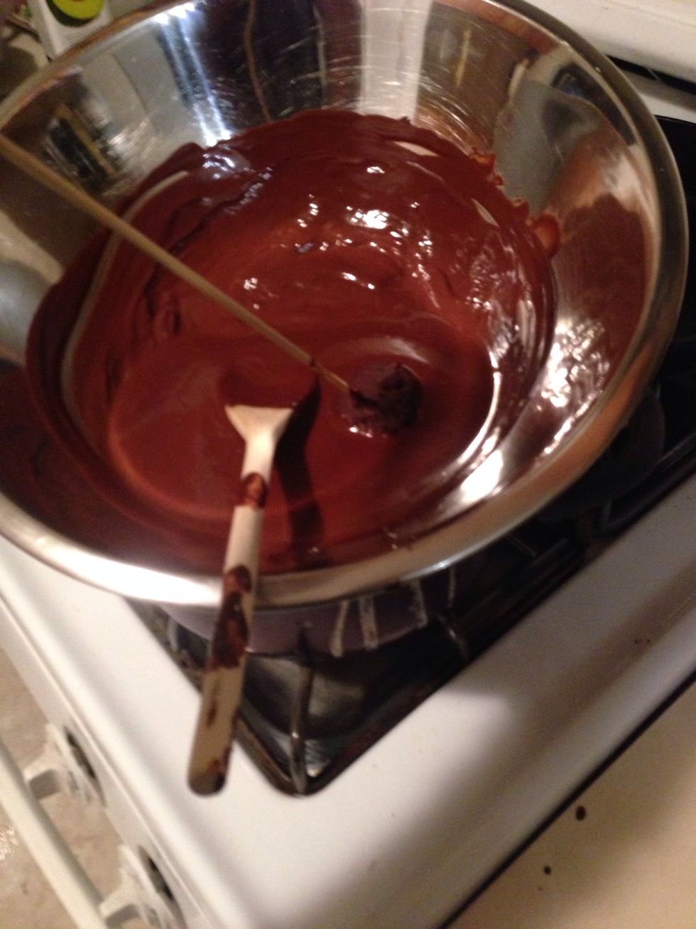 Use a wooden skewer to put the balls into the melted coveture chocolate. Latex gloves will make it easier to clean your hands afterwards.