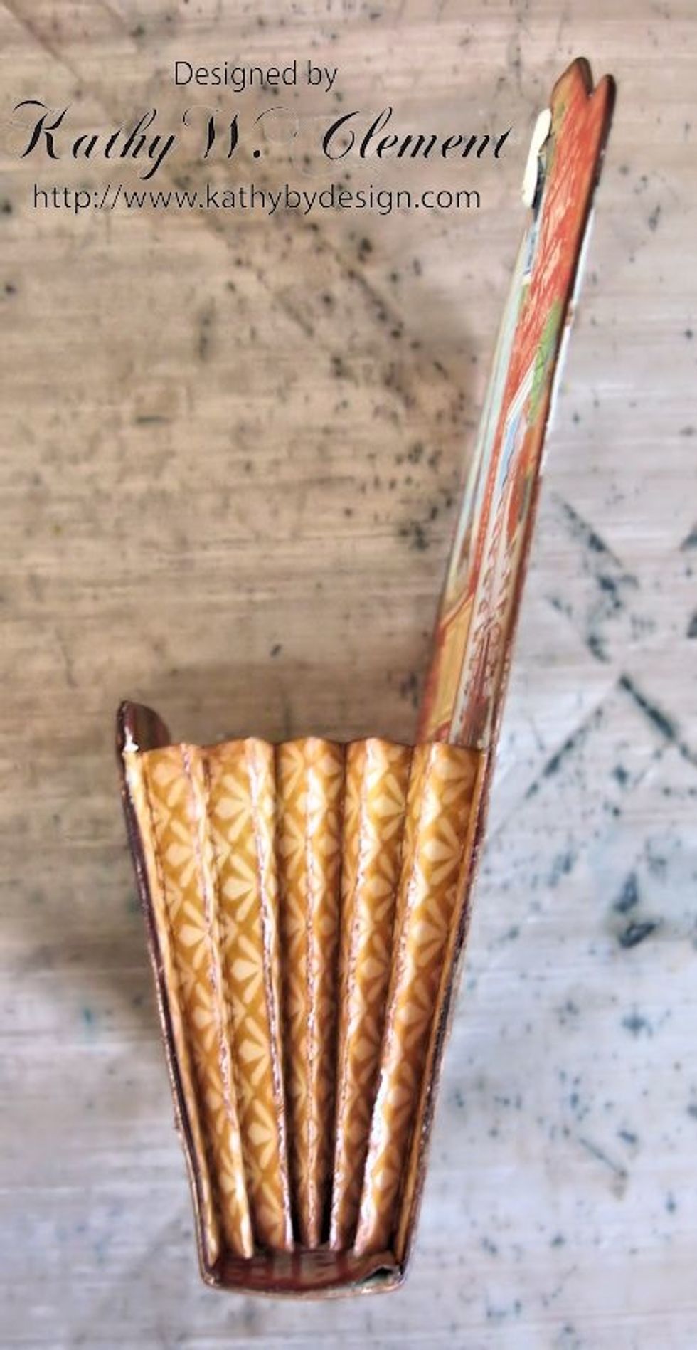 Use adhesive to add the accordion pleats to each side of the pocket as seen in this photo.