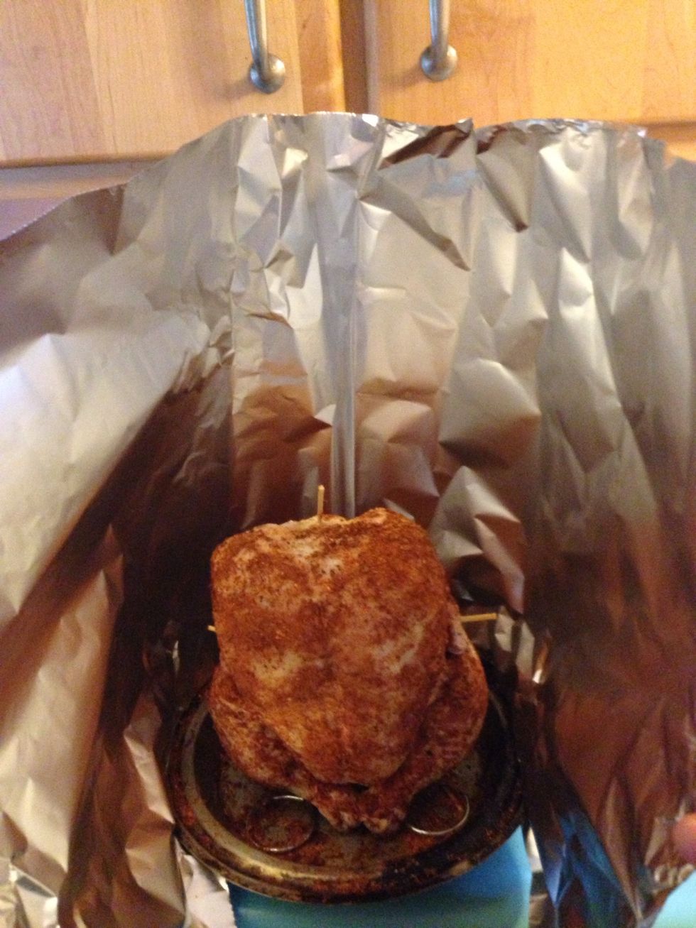 Use aluminum foil to make a tent. Pinch the foil tightly at the edges of the pie pan. Pinch at side and top seams making sure it is sealed. This will help the bird cook evenly and retain moisture.