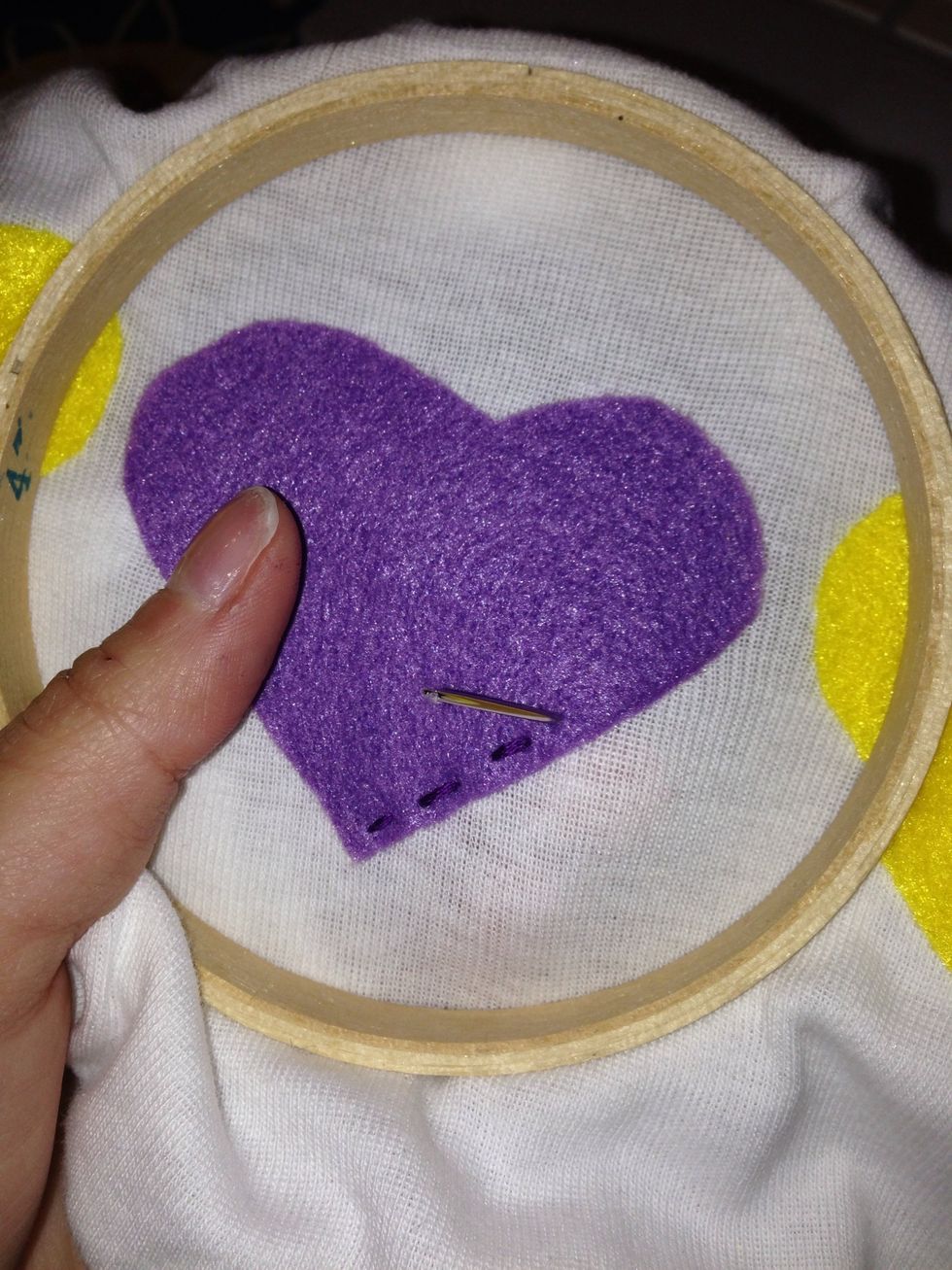 Use an embroidery hoop and hand stitch around to edge of the felt object.
