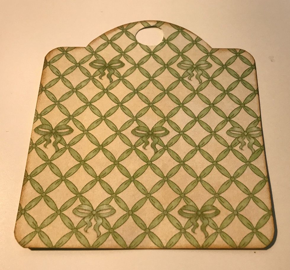 Use an Ivory tag and trace the tag on the green lattice paper. Cut tag out. Punch circle at top of paper using 1/2" circle punch. Ink edges of tag using Vintage Photo Ink & blending tool with foam.