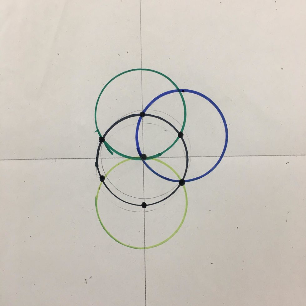 Use another marker to make a 4th circle. Line the cup with the 1st center dot and the two closest to create a circle on top right.